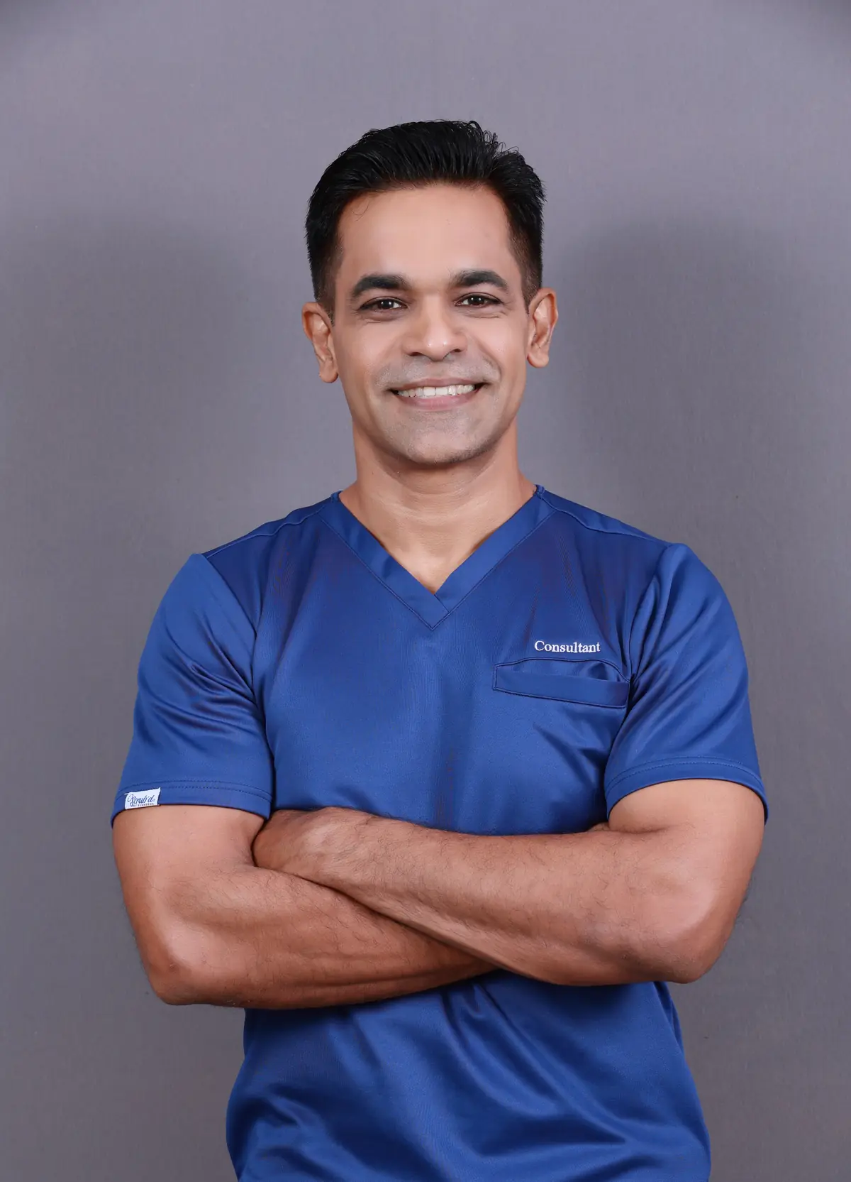 Dr. Prageeth portrait in clinical attire.