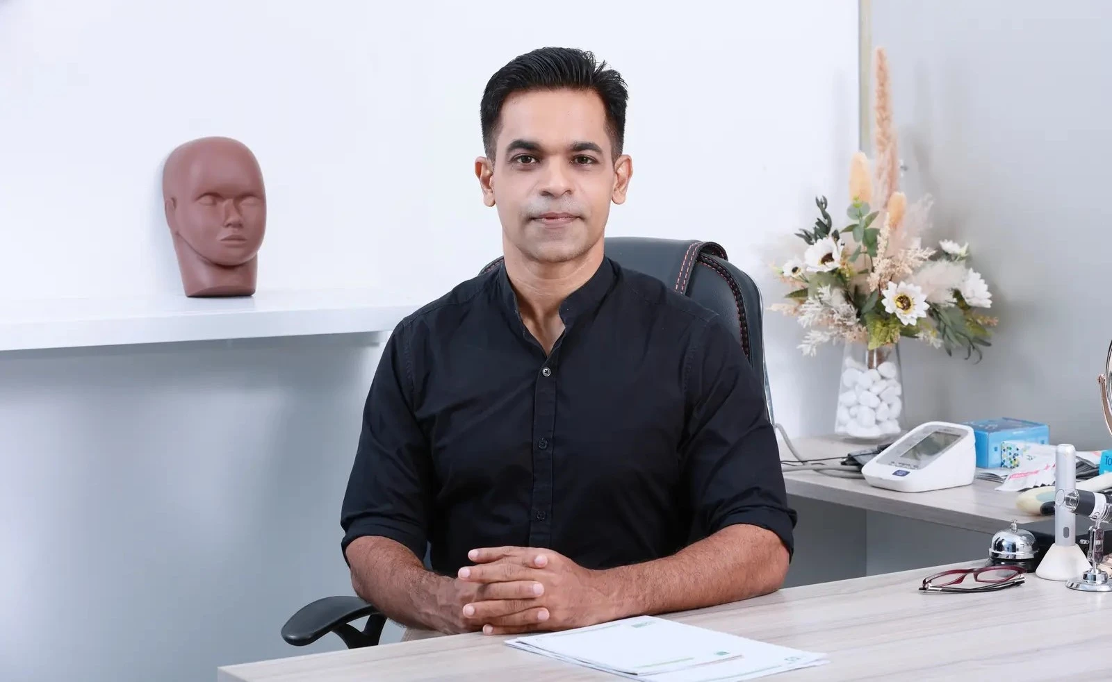 Dr. Prageeth in a clinical consultation setting.